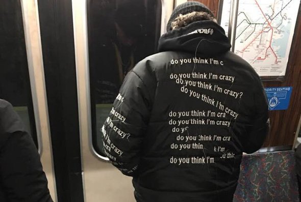 Man on Orange Line with jacket that asks if you think he's crazy