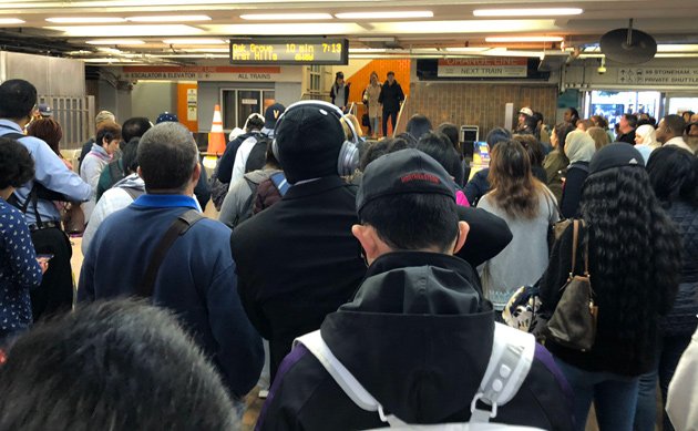 People waiting at Malden Center on the Orange Line
