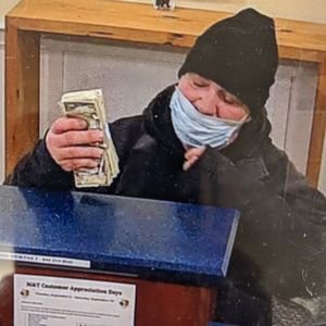 Mr. Moneybags holding up fresh cash at Back Bay bank