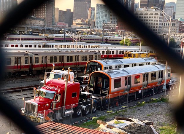 Orange Line cars being dropped off at a Red Line yard