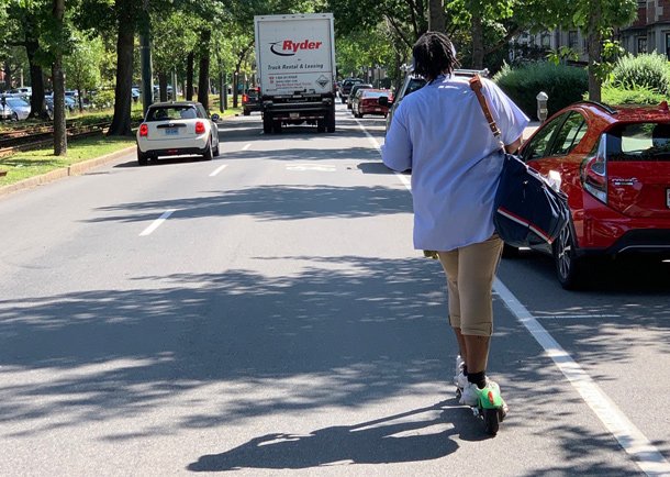Brookline postal worker on a rental scooter