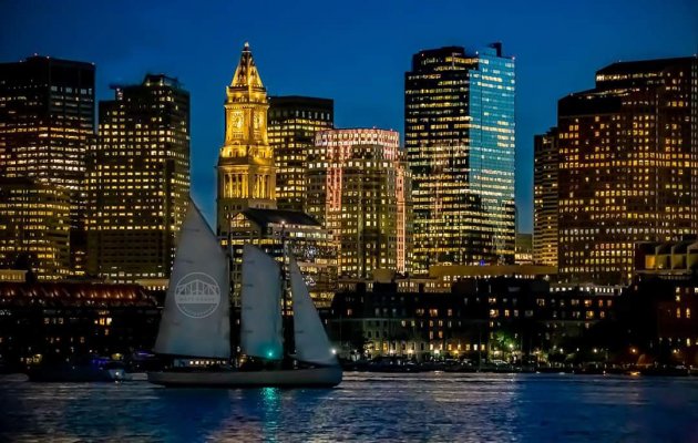 Sloop passes in front of downtown Boston