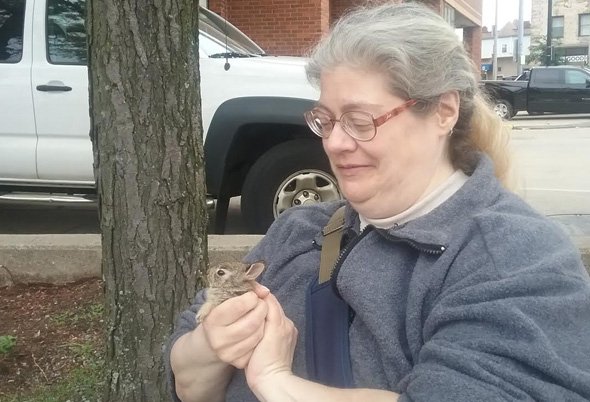 Woman with baby rabbit in Allston