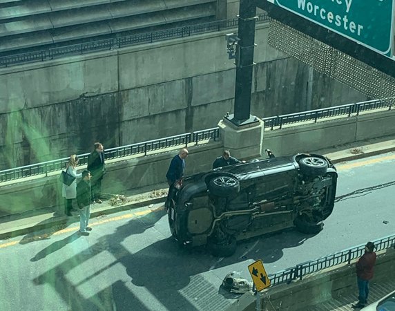 Car on its side at I-93 entrance near South Station