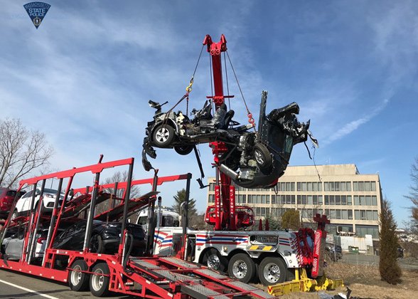 Remains of a vehicle removed from car carrier in Peabody