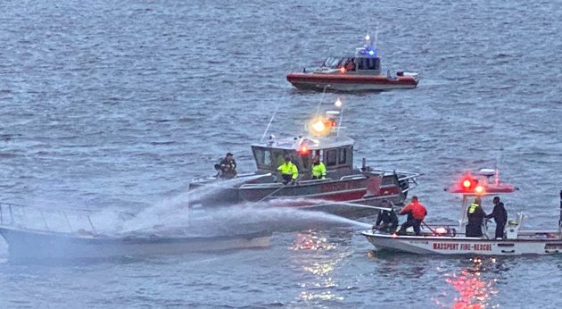 Boston and Massport fire crews pour water on burning boat