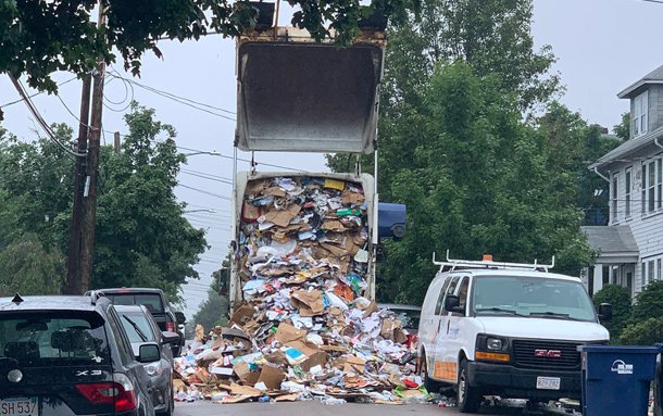 Recycling truck disgorging its contents in West Roxbury