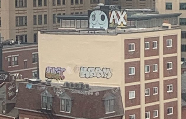 Graffiti showing either an angry owl or boobs, depending on how you see them