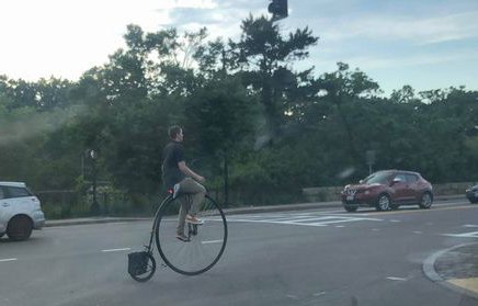 Guy riding a penny farthing in Forest Hills