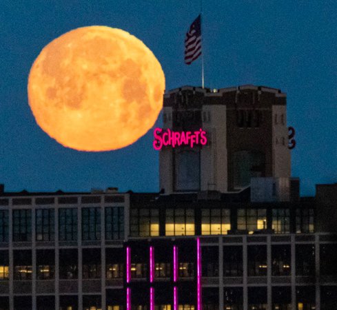 Moon sets over the Schrafft's Building in Charlestown