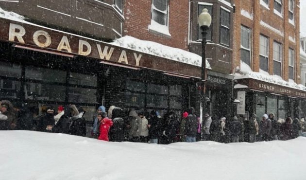 Line outside the Broadway in South Boston in the snow