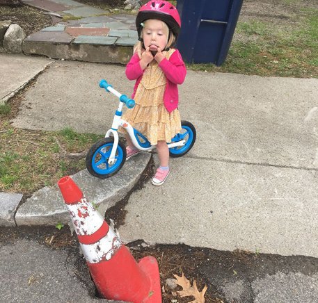 Kid complaining about a pothole in West Roxbury