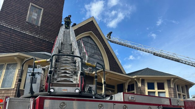 Firefighters up ladders at Boylston Congregational Church