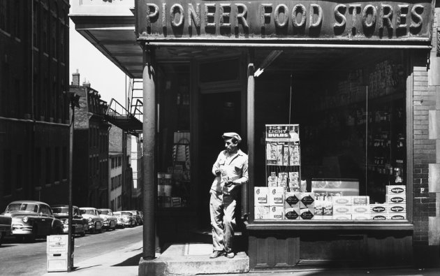 Man leaning against window of Pioneer Food on Beacon Hill