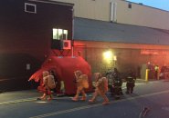 Firefighters in hazmat suits at marine industrial park ammonia spill