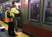 Workers trying to fix door on a Red Line train in Boston