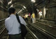 People being evacuated from a Blue Line train in a tunnel