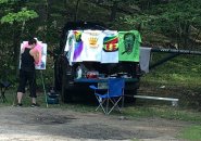 People selling T-shirts in the forest