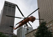 Orange helicopter hovers in downtown Boston