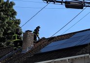 Firefighters on roof in Roslindale