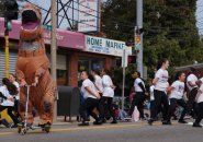 Dinosaur and dancers in Roslindale Day Parade