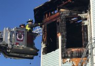 Firefighters inspect 688 Columbia Rd, in Dorchester after fire is knocked down