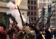 Minutemen firing muskets in downtown Boston