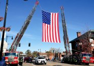 Big flag draped over Centre Street in West Roxbury to honor World War II flyer