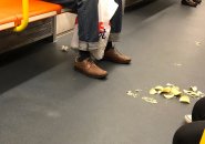 Chips, other trash on the floor of a new Orange Line car