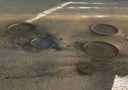 Multiple potholes and Veolia manhole covers