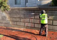 Public Works employee removing graffiti
