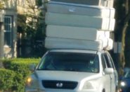 A lot of mattresses on one car in Brookline