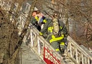 Firefighters from Ladder 4 rescue child at West Newton Street fire.