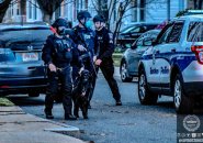 Armored Boston police officers at the scene with a K-9.