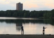 Two people fishing at Jamaica Pond at twilight