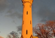 Orange Fort Hill water tower at sunset