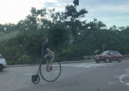 Guy riding a penny farthing in Forest Hills