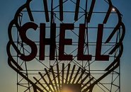 Sun coming through the Shell sign on Memorial Drive at sunset