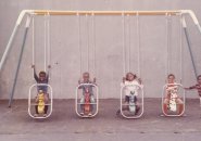 Kids on swings in old Boston