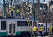 Workers atop a Green Line trolley on Beacon Street