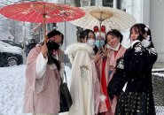 Women with umbrellas in the snow in Allston