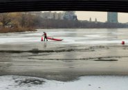 Man picking up cones on the Charles River