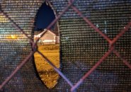 Hole in fence at dirt dump