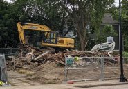 What's left of 19th century house on Centre Street, with backhoe on top