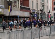 People running down Boylston Street