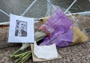 Two bouquets, a note and a photo on the Public Garden bridge