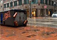 Big Belly trash receptacle pushed over by wind on State Street