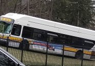 Bus on grass with missing windshield