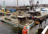 Sunk boat is raised up in Boston Harbor