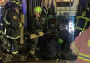 Firefighters work to free woman from under a trolley at BU Central